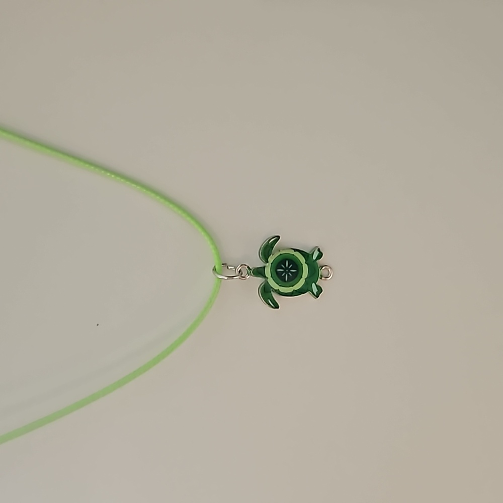Turtle charm on leather corded necklace